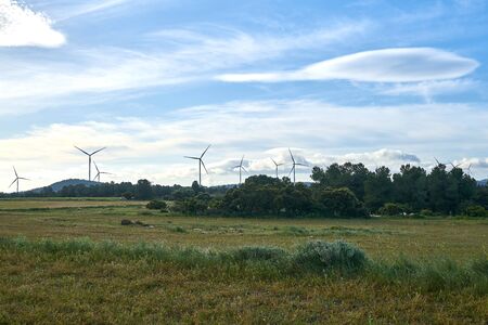 Beautiful image of the field with ecological windmills to generate electricity in a natural environmentの写真素材