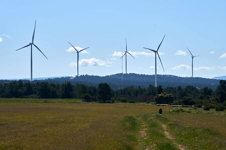 Beautiful image of the field with ecological windmills to generate electricity in a natural environmentの写真素材