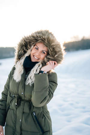 Woman in snow winter landscape warm jacket sexy black bootsの写真素材