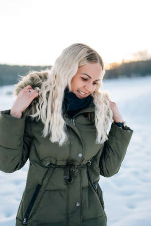 Woman in snow winter landscape warm jacket sexy black bootsの写真素材