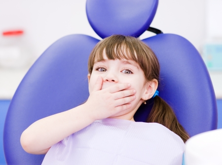 frightened girl at dentist s office frightened girl at dentist s office