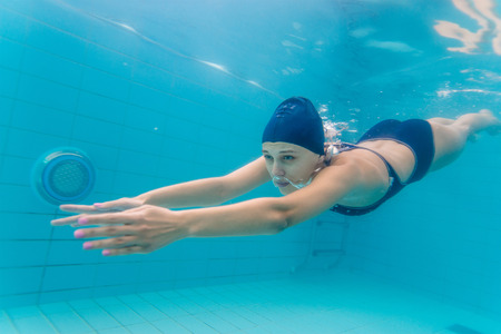 Woman swimming underwater in pool. Woman swimming underwater in pool.