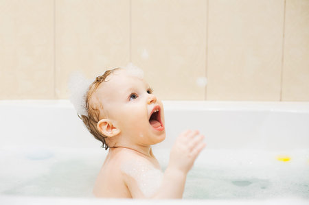 Happy cute smiling, baby girl in bathroom