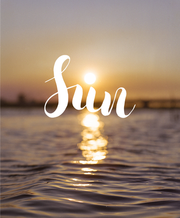 Conceptual hand drawn lettering  - Sun. Calligraphy. Great design for postcard, t-shirt, poster, invitations, stickers, banners, advertisement. Bright, colorful sunset background.の写真素材
