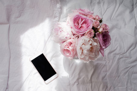 Beauty flat lay with phone and flowerの写真素材