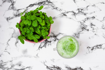 Healthy vegan food concept. Proper nutrition. Green smoothie with apple, kiwi, spinach. Superfood, detox and healthy food. Close up of blender shaker  on black and white background.の写真素材