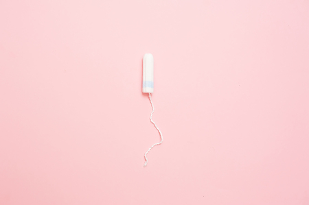 Clean white cotton tampons on pink background. Menstruation. Feminine Hygiene in periods, beauty treatmentの写真素材
