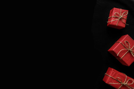Christmas composition with red boxes, presents and gifts on black background. Flat lay. Holiday conceptの写真素材