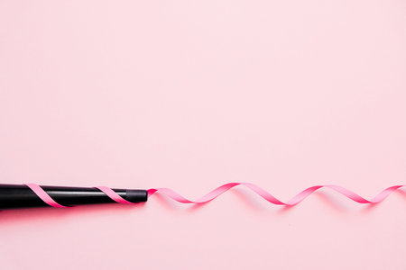 Cone curling wand iron. Professional hairdressers equipment on color background. Concept of curly...