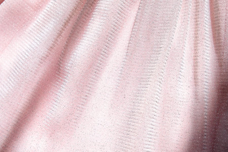 Beautiful delicate pink background. Shiny mesh fluffy fabric close-up texture.
