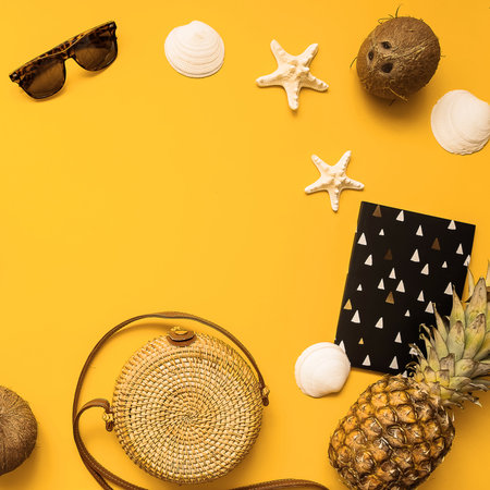 Summer traveler accessories flat lay. Straw hat, retro film camera, bamboo bag, sunglasses, coconut,...