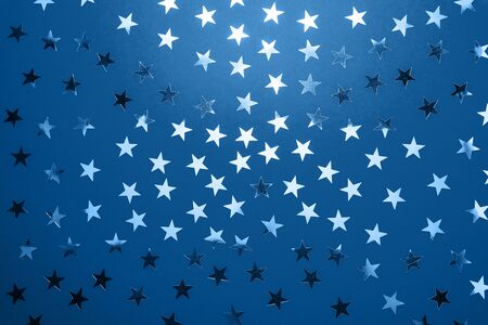 Color of the year 2020 Classic Blue with Silver star sprinkles. Festive holiday confetti. Celebration conceptの写真素材