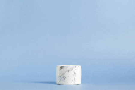 Empty white marble podium on pastel blue color background. Minimal boxes and geometric podium. Scene with geometrical forms. Empty showcase for cosmetic product presentation. Fashion magazine.の写真素材