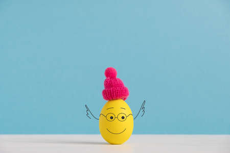Happy egg in hat. Easter holiday concept with cute eggs with funny faces. Different emotions and feelings.の写真素材