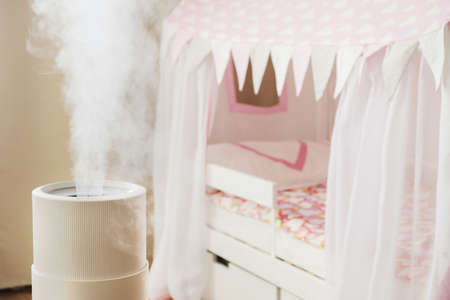Modern air humidifier in childrens room, aroma oil diffuser at home. Improving the comfort of living in a house, Improving the well-being. Baby careの写真素材