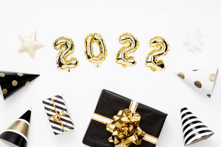 Happy New year 2022 celebration card. Gold foil balloons numeral 2022 on white background. Gifts and...