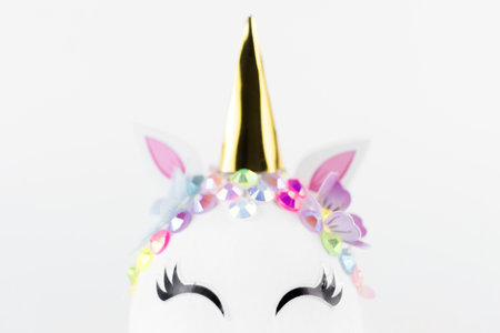 Easter unicorn head egg isolated on white background. Happy easter banner. Kids activity inspiration. Greeting card or poster. Copy space for textの写真素材