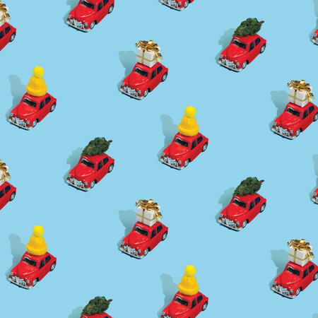 Christmas pattern made with New Year red cars with gifts, pine trees and hats on light blue...