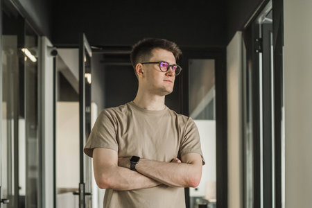 Headshot portrait smart businessman in glasses sitting at work desk in modern office, looking at camera, confident satisfied student freelancer posing for photo at workplaceの写真素材