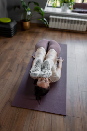 A detailed closeup of a foot work and core exercise on yoga mat symbolize a state of fitness,...