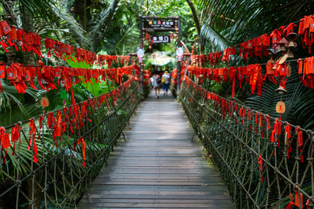 The vibrant and colorful bridge is beautifully surrounded by lush greenery and natureの写真素材