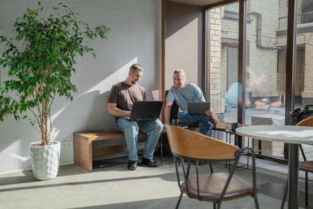 Two knowledgeable professionals collaborating effectively together in a modern workspace settingの写真素材