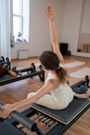 Pilates group of Women doing mermaid exercise in a sunlite modern studio, embodying calm, focus, and strength.の写真素材