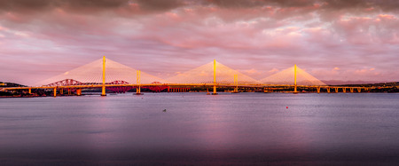 Last rays of sun hitting the 3 bridges across the Firth of Forth, Scotlandのeditorial素材