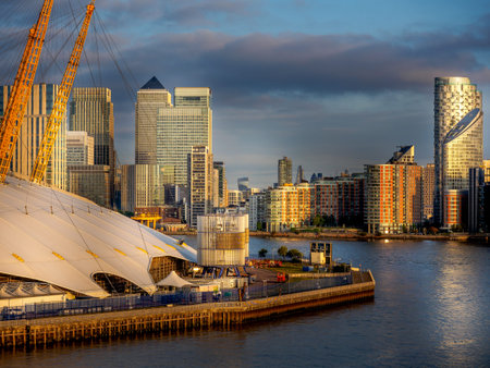 Easly morning sun rising over Cananry Wharf and the River Thames, London