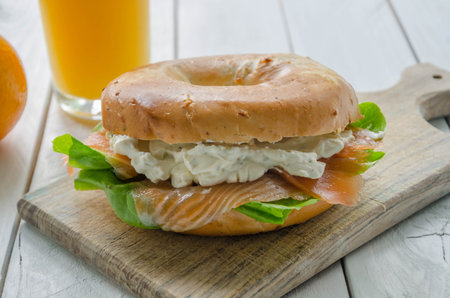 Sandwich with smoked salmon, cream cheese, lettuce and orange juiceの写真素材