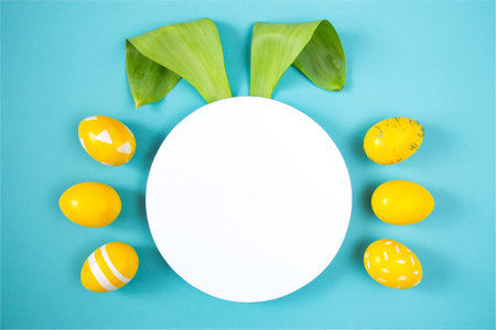 Happy Easter minimal concept. Bunny rabbit face made from natural green leaves and white paper...