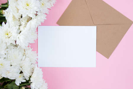 White flowers on a pink pastel background. Festive floral concept with clean text space. flat lay. view from above.の写真素材