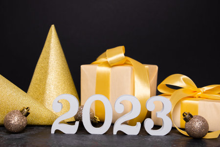 White numbers in the shape of figure 2023 on a black background. The concept of celebrating the new...