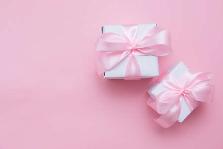 Gift boxes tied with a pink bow. Postcard, top view, flat lay.の写真素材