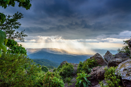 Golden rays of sunlight through stormy clouds over Vitosha mountain, Bulgariaの写真素材