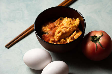 Scrambled eggs with tomatoes is a home cooked meal in Taiwan,China and other east asia area.Scrambled eggs with boiled tomatos,based with tomato sauce and pepper,sugar and salt.の写真素材