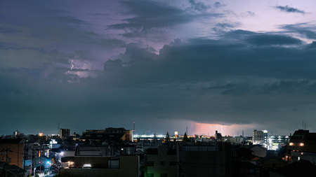 material cityscape photo of thunder storm and rain cloudsの写真素材