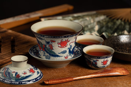 chinese traditional porcelain tea cup and tea leaf on wooden ancient board
