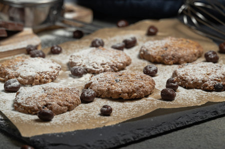 homemade chocolate cookie dressed with sugar and black background.