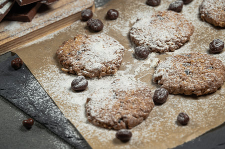 homemade chocolate cookie dressed with sugar and black background.