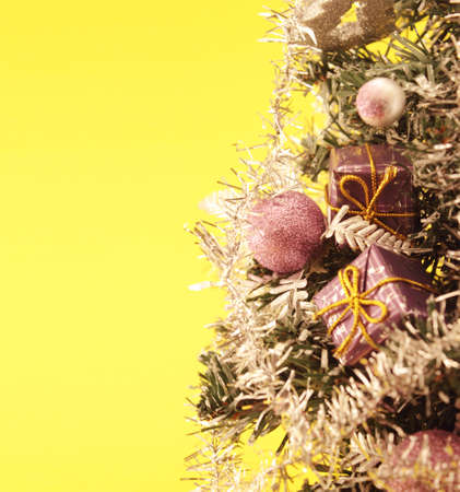 Christmas tree with decorations on yellowの写真素材