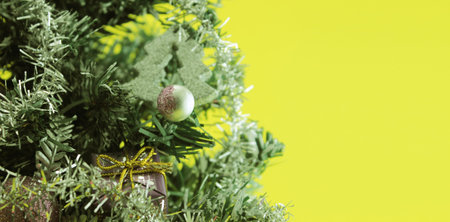 Christmas tree with decorations on yellow