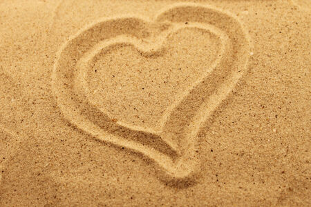 Heart drawn in the sand. Conceptual image for love or valentines day.の写真素材