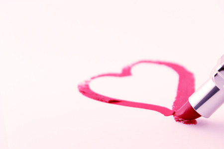San valentine pictures. Close-up of a heart painted with lipstick isolated on white.の写真素材