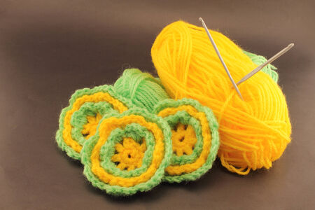 Fun crafts to do at home. Flowers woven wool crochet. Using wool two colors for different flower petal.の写真素材
