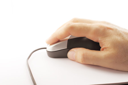 Hand Working with a computer mouse. Silver and black.の写真素材