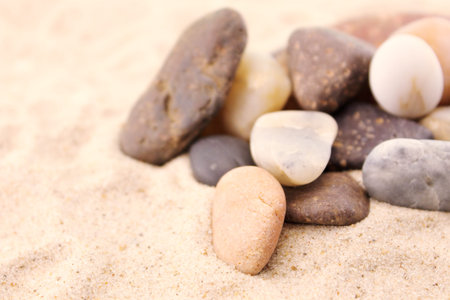 Conceptual image about the holiday with sea stones on the sandの写真素材
