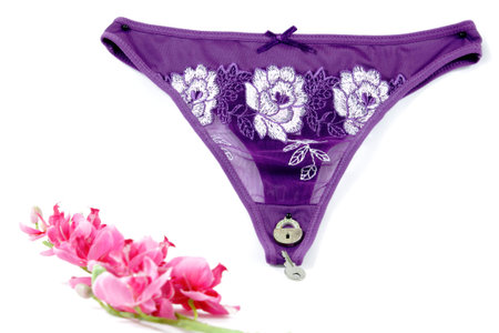 Conceptual image. A mask and a Sexy panties purple with a small padlock and key to open it.の写真素材