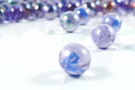 Green glass marbles reflecting window.の写真素材