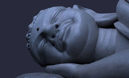 Sleeping Buddha on a blue abstract background.の写真素材